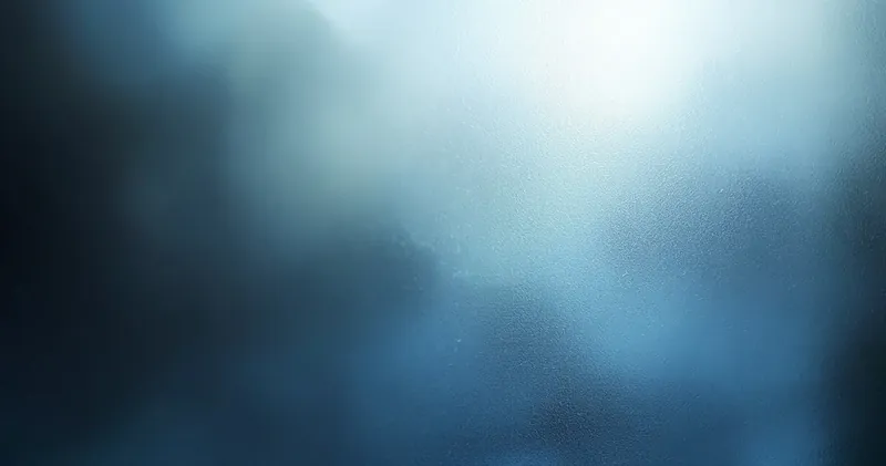 Soft blue-grey light through a frosted window pane (illustration)
