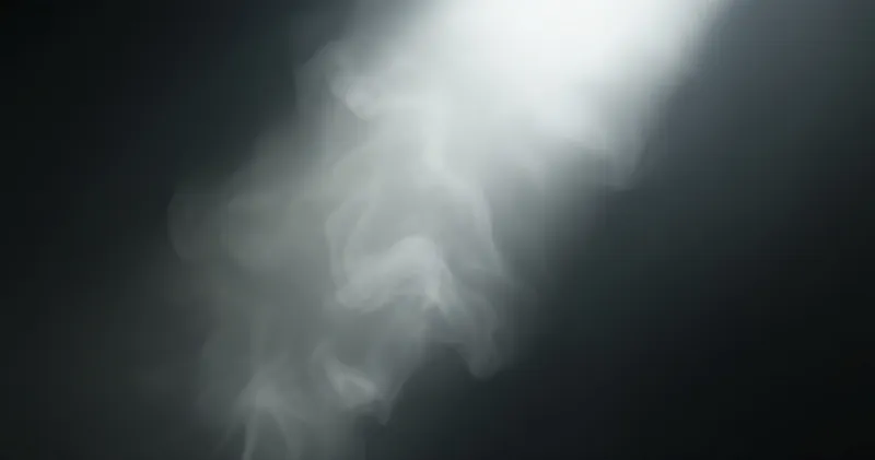 Soft steam rising in a shaft of pale light against a dark background (illustration)