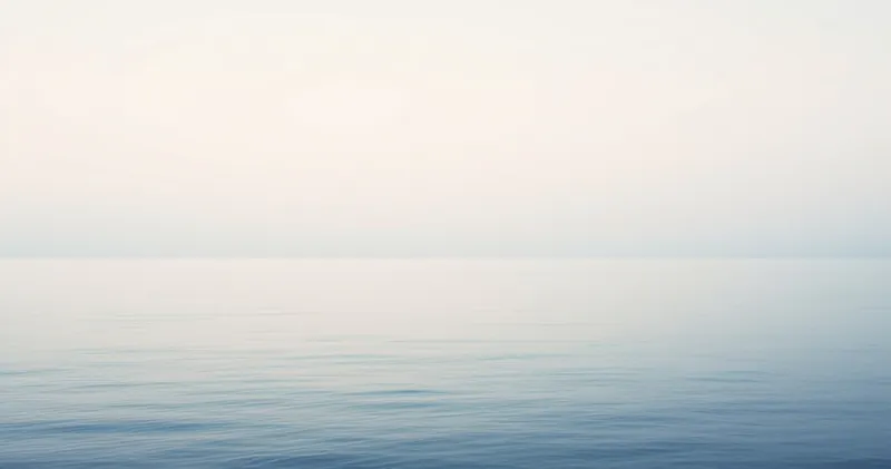 Calm sea horizon where water and sky meet in a soft gradient (illustration)
