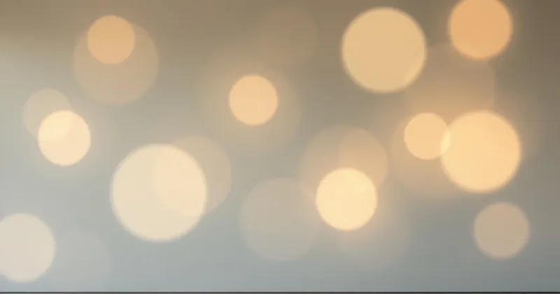 Overlapping soft circles of warm light on a plain wall (illustration)