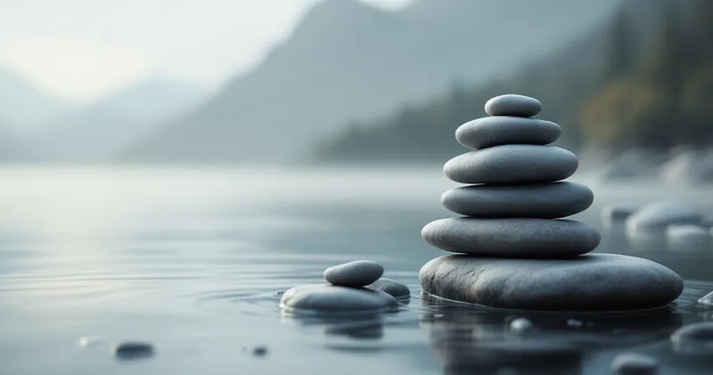Smooth stacked stones beside still water in soft light (illustration)