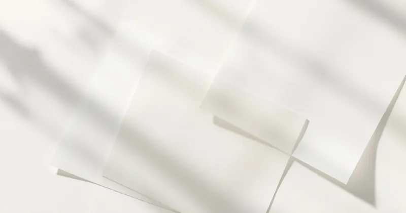 Overlapping translucent paper sheets on a light surface (illustration)