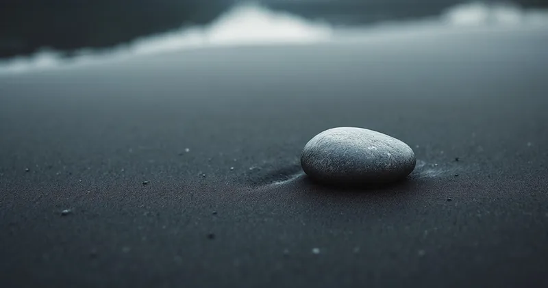 Single smooth river stone resting on wet dark sand (illustration)
