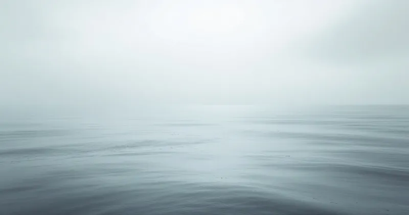 Soft grey overcast light across still water (illustration)